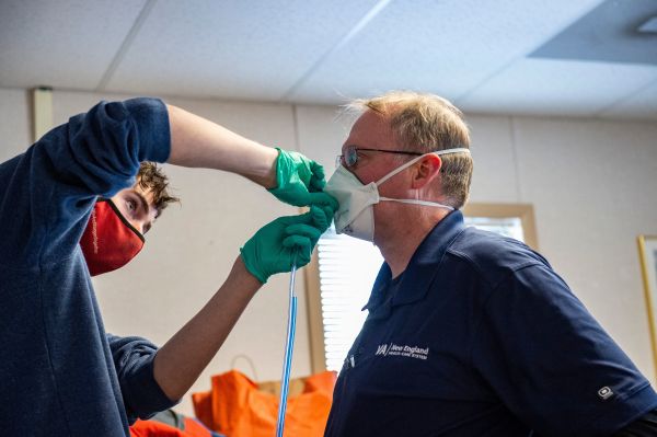 图为2022 年 1 月 11 日，在美国马萨诸塞州西罗克斯伯里（West Roxbury）的美国退伍军人事务部 (VA) 波士顿医疗中心的一名医务人员在为一名医院工作人员测试 N95 口罩。该中心目前有 20 名Covid- 19患者住院。（图片来源：JOSEPH PREZIOSO/AFP via Getty Images）