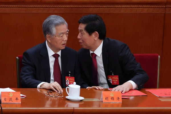 2022年10月22日，中共中央政治局常委栗战书（右）在中共二十大闭幕式上与中国前国家主席胡锦涛（左）交谈