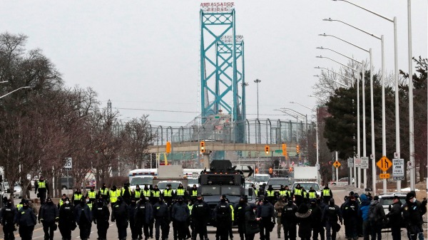 2022年2月13日，加拿大警察清除反对Covid-19疫苗授权的抗议者，他们封锁了安省温莎大使桥的入口。（图片来源：JEFF KOWALSKY/AFP via Getty Images)