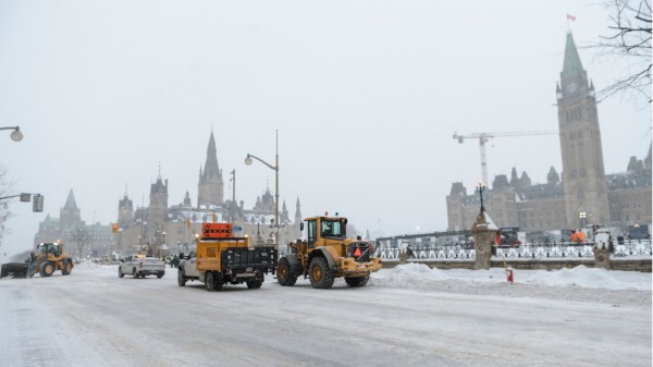 2022年2月20日，警察和市政雇员在加拿大首都渥太华清理先前被自由车队占领的国会山前的威灵顿街。（图片来源：ANDREJ IVANOV/AFP via Getty Images）