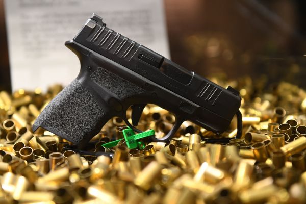 2022 年 5 月 28 日，在美國德克薩斯州休斯頓舉行的全國步槍協會（NRA）年會上展示的一把已經發射了2萬發子彈的 Springfield Armory Hellcat 9 毫米微型手槍和空彈殼。在美國槍擊案頻繁發生的情況下，左派人士們推動嚴格限制槍支，而保守派人士們則推動允許人們可以在不需要許可證的情況下隱蔽攜帶手槍以在萬一的情況下可以自衛。（圖片來源：PATRICK T. FALLON/AFP via Getty Images）