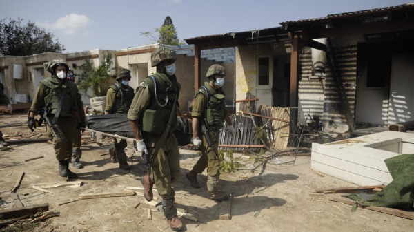 10月10日，以色列士兵移走一具被哈馬斯殺害的平民屍體。