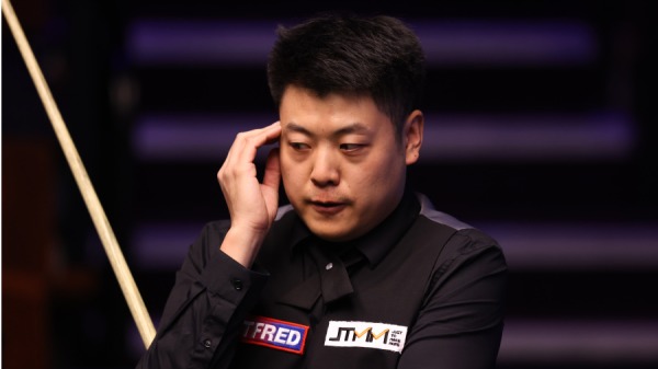 2021年4月18日，中国选手梁文博在英国谢菲尔德举行的 Betfred 世界斯诺克锦标赛第一轮比赛中作出反应。