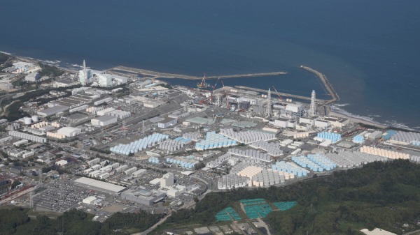 2023年8月24日，在福島縣大熊市東電受損的福島第一核電站用於儲存處理過的水的儲罐（底部）。