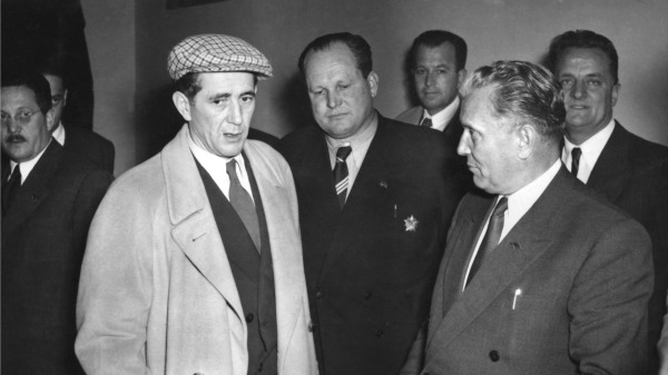 1952 年11 月南斯拉夫共产主义联盟代表大会期间，吉拉斯（左，戴帽子）与南斯拉夫总统铁托谈话。