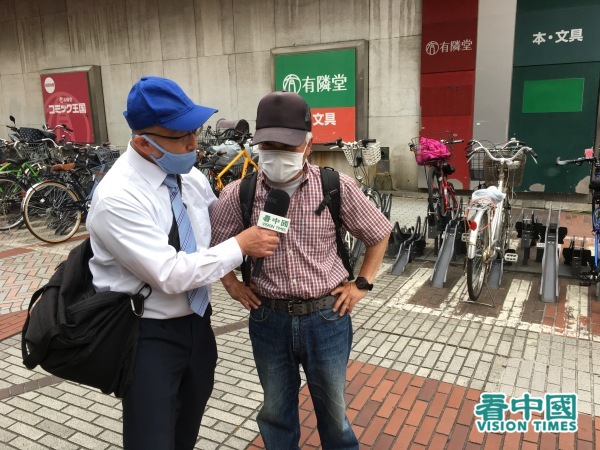横滨市的居民江原先生接受看中国记者采访。
