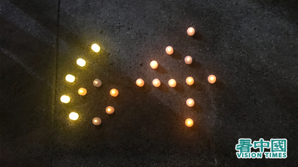 2020年6月4日，香港市民在维多利亚公园地上把蜡烛摆放称“64”字样。（摄影：看中国记者）